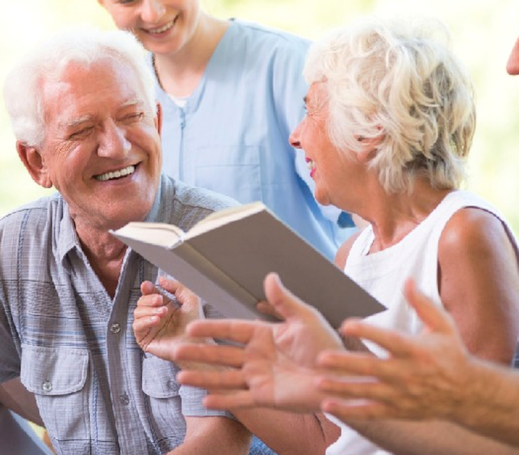 Older adults enjoying reading and conversation together